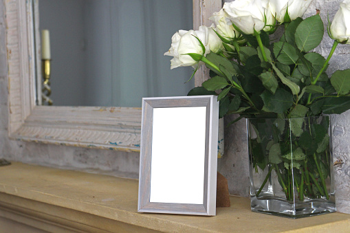A small photo frame on a mantlepiece