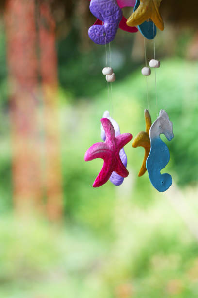 Close-up view of hanging mobile of aquatic animals with blur background.