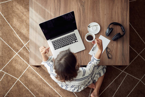 istock woman relaxing at home with laptop computer and drinking coffee top view 1213657179