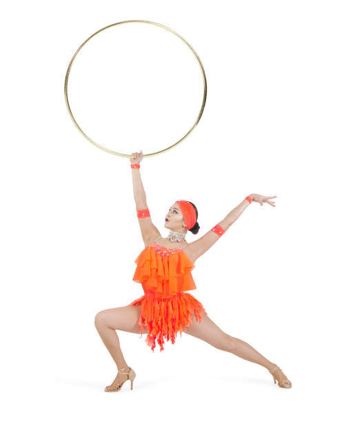 istock A girl in a stage dress performs a dance with a hula Hoop. 1213657266