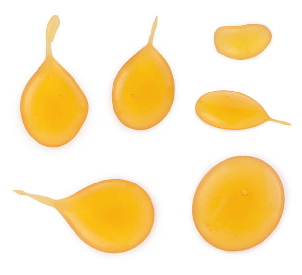 istock Liquid natural honey or maple syrup yellow different drops in circle shape isolated on white background 1213658688