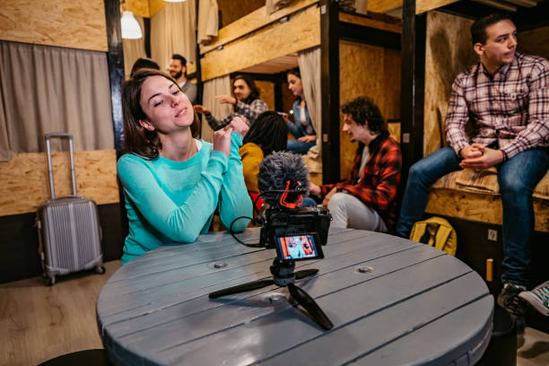 istock Woman vlogging from her hostel room 1213661111