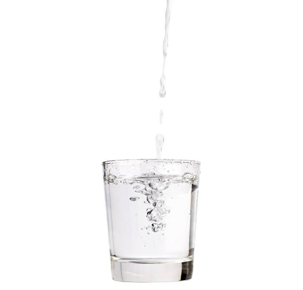 istock Pour water into a glass isolated with clipping path included. 1213661572