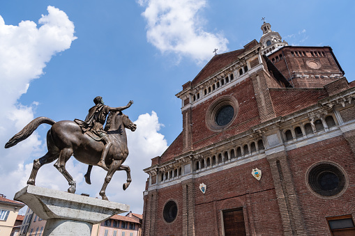 Pavia, Italy - May 9, 2018: Duomo of Pavia with equestrian statue Regisole, Lombardy region. The Sun King of (Regisole) was a classical equestrian bronze monument, very influential during the Italian Renaissance but destroyed in 1796. The statue currently visible is a copy of the original made by the sculptor Francesco Messinar on the basis of ancient reproductions