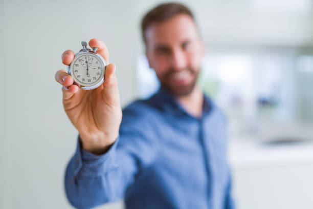 istock Handsome man showing stopwatch 1213664808