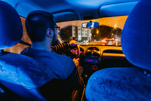 istock Man driving car on city streets 1213666203