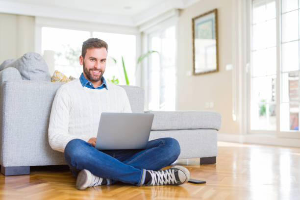 istock Handsome man wearing working using computer laptop with a happy face standing and smiling with a confident smile showing teeth 1213666373