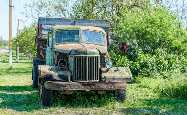 istock Old rusty truck on the green spring rural field 1213667527