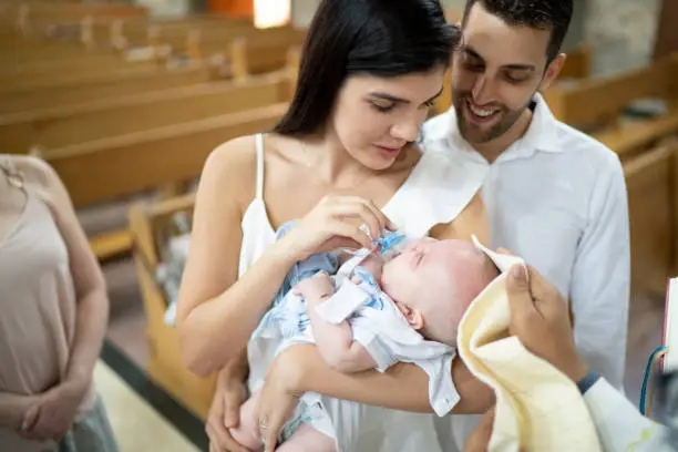 Godparents with a godson baby at baptism celebration