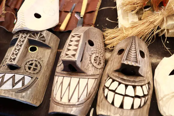 Wooden mummer masks on counter at market
