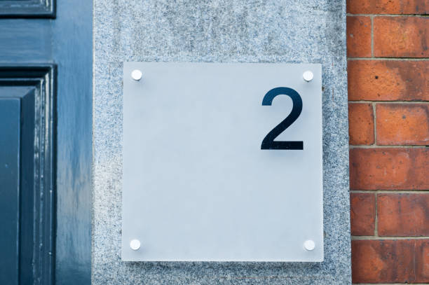 istock Frosted perspex panel showing number two with red brick and painted wooden door background 1213673362