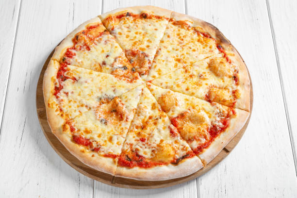 Pizza with tomato sauce and different types of cheese stock photo