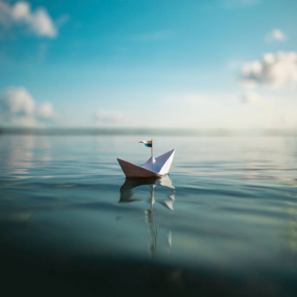 istock Freedom - small paper ship on the waves 1213674667