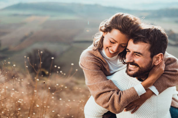 istock Affectionate couple having fun while piggybacking in autumn day outdoors. 1213675252