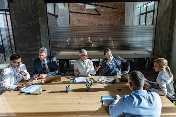istock Businessmen and medical experts working at doctor's office. 1213677343
