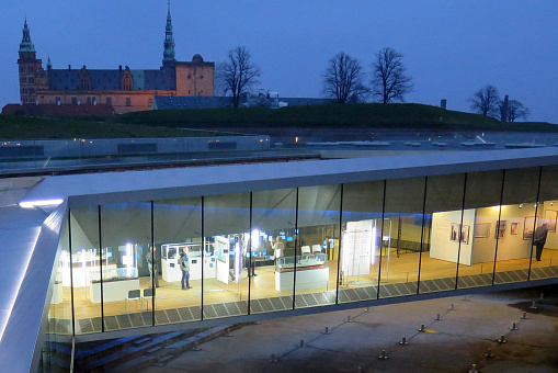 Night time shot of the Danish Maritime Museum with Kronborg Castle in the background (made famous as the setting for William Shakespeare's play Hamlet)