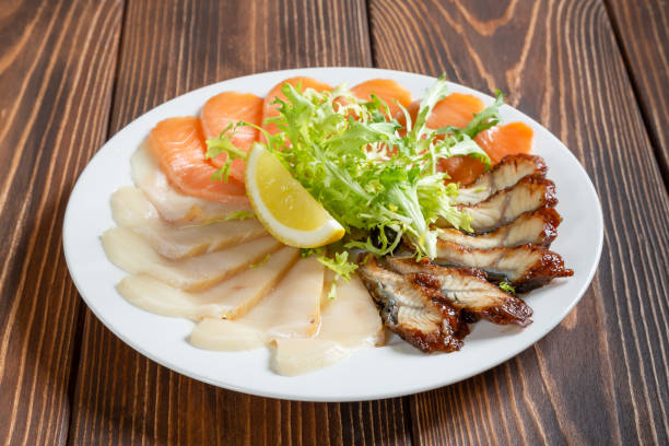 Mixed fish plate on wooden table. Cold starter. stock photo