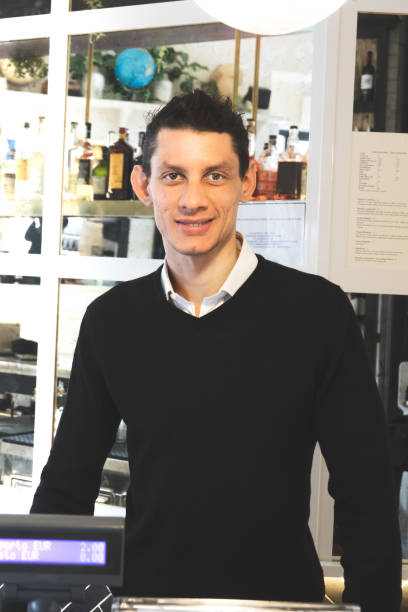 Employee Behind Counter Stock Photos, Pictures & Royalty-Free Images