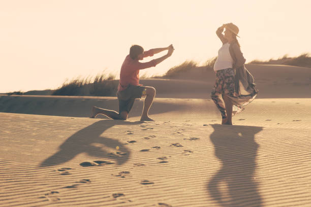 istock Happy young spouse taking photos on beach 1213678555