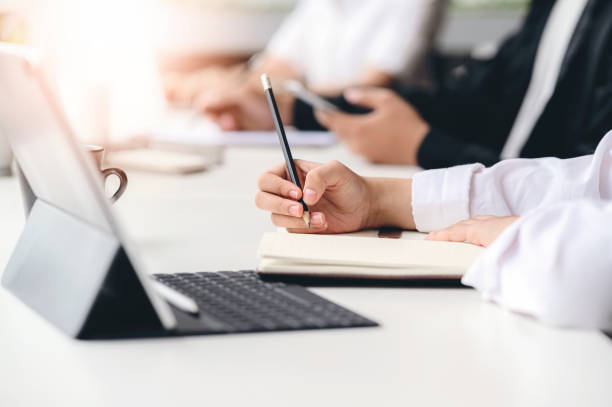 istock Cropped shot of woman hand writing on diary while working at office. 1213679402