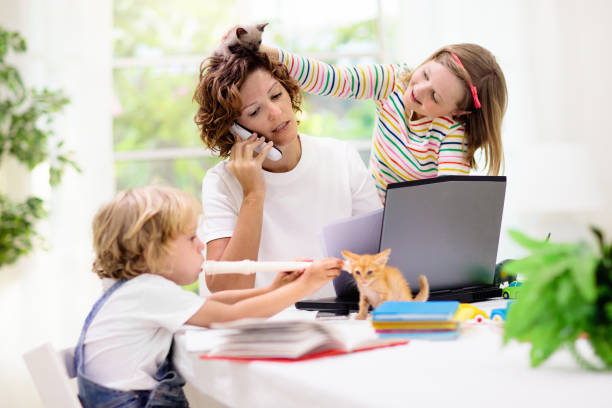 Mother working from home with kids. Quarantine. Mother working from home with kids. Quarantine and closed school during coronavirus outbreak. Children make noise and disturb woman at work. Homeschooling and freelance job. Boy and girl playing. irritation stock pictures, royalty-free photos & images