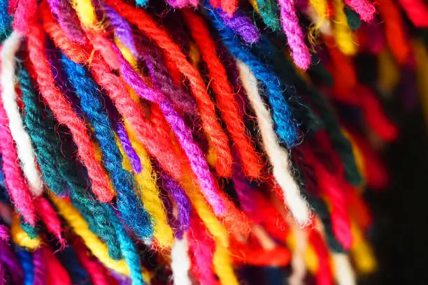Photo of Trimming yarn. Colorful collection of wool for knitting and weaving. Multicolored woolen yarn background