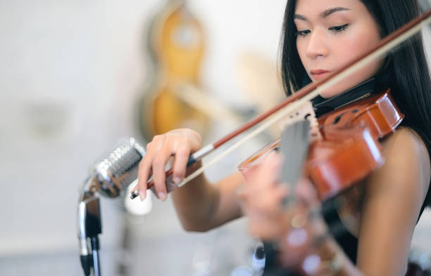 istock Beautiful asian woman playing violin. 1213684026