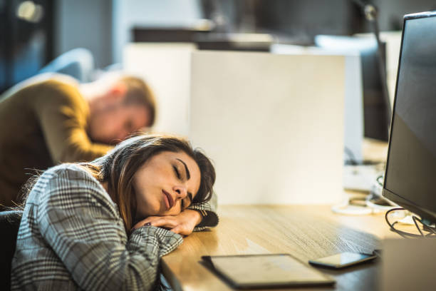 istock Tired female programmer taking a nap in the office. 1213684712