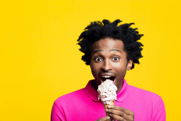 istock Excited young man eating ice cream 1213684774