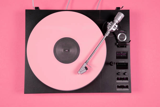 istock Colored vinyl record on a pink background with copy space. Top view. 1213684814