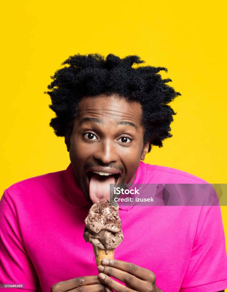 headshot-of-excited-young-man-eating-chocolate-ice-cream.jpg
