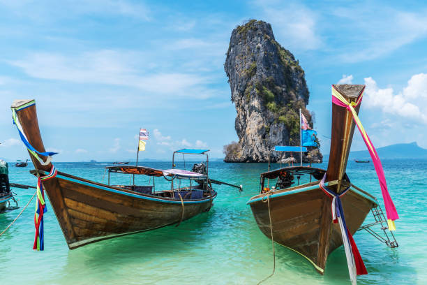 thai traditional wooden longtail boat and beautiful sand beach at koh poda island in krabi province.  ao nang, thailand ,krabi island is a most popular tourist destination in thailand - thailand beach nautical vessel phuket province imagens e fotografias de stock