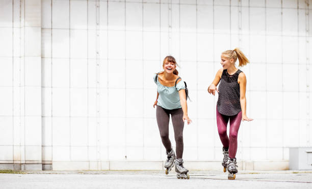 istock Two girls rollerskating and hanging out 1213685592