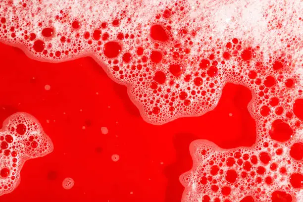 Soap foam texture red background
