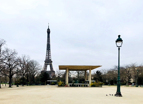 Eiffel Tower and Champ-de-Mars empty, during pandemic in 2020, in Europe. There are no more people. Schools, shops, restaurants, .. are closed. Everybody is confine at home.