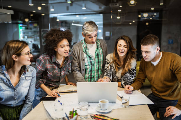 istock Group of freelance workers working on a laptop in the office. 1213688541