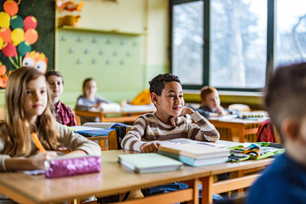 istock Smiling African American schoolboy on a class at elementary school. 1213689399