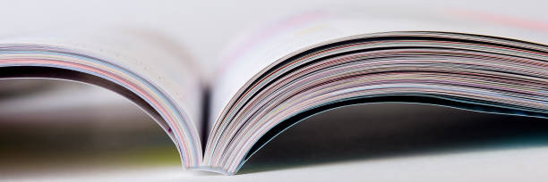 istock Colorful pages of an open magazine, close up. Selective focus. 1213689708