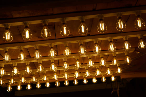 istock The row of incandescent bulbs. Lights background. 1213689860