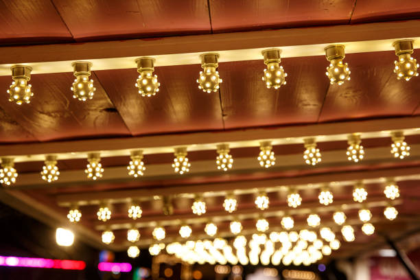 istock The row of incandescent bulbs. Lights background. 1213689914