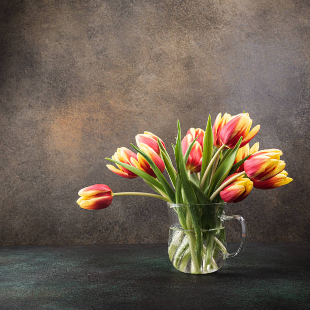 istock Red yellow tulips in glass vases 1213690002