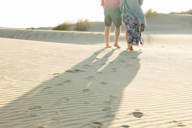 istock Cropped shot of young couple strolling on sandy beach 1213692462