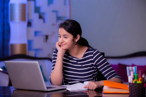 Teenager girl doing her homework stock photo Teenager, Homework, Learning homework photos stock pictures, royalty-free photos & images
