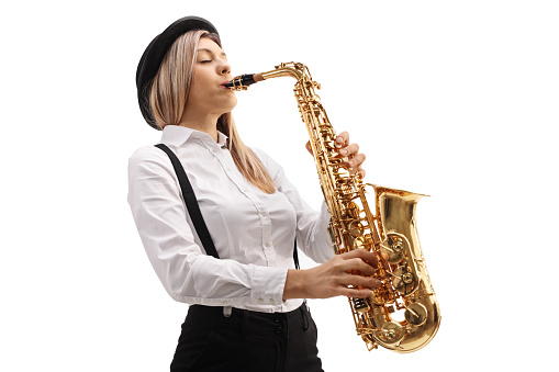 Young female musician playing a saxophone isolated on white background