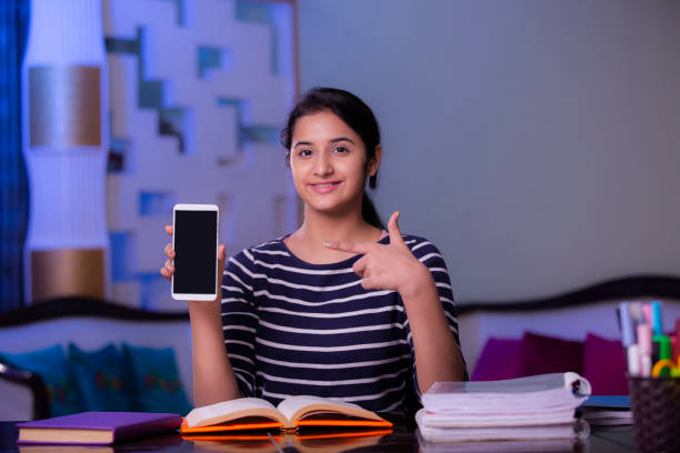 teenager girl with mobile phone stock photo - homework teenager mobile phone school imagens e fotografias de stock