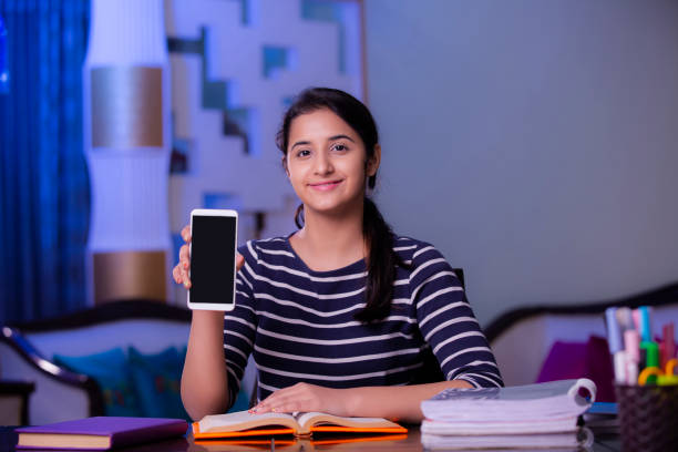 teenager girl with mobile phone stock photo - homework teenager mobile phone school imagens e fotografias de stock