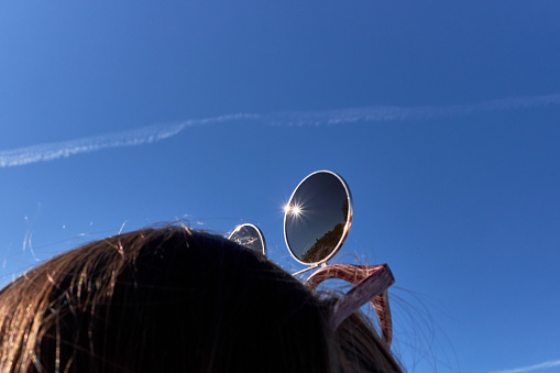 sunglasses on the girl's head and blue sky