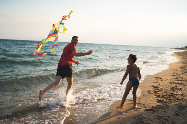 istock Father and son flying a kite 1213698809