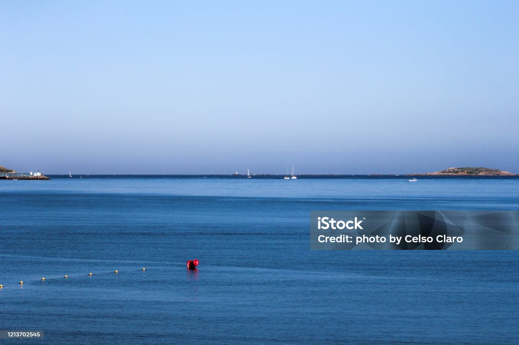 seascapeby the beach boats and a buoy on a light blue sea Backgrounds Stock Photo