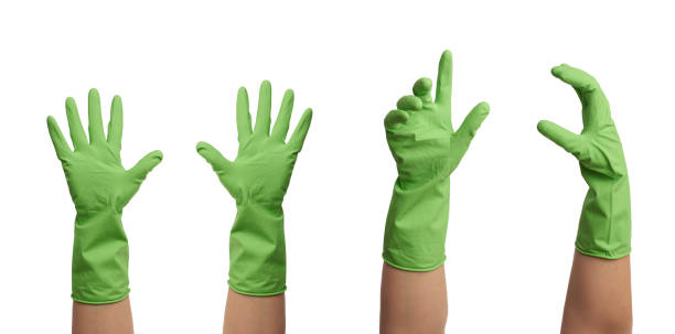 green rubber glove for cleaning is dressed on the hand